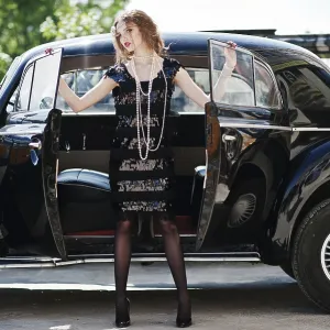 Portrait of beautiful sexy curly fashion girl model with bright makeup in retro style near vintage car