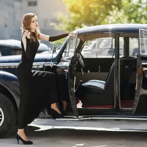 Portrait of beautiful sexy fashion girl model with bright makeup in retro style near vintage car with a cigarette