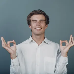 Portrait european young man portrait at studio with ok mudra sign yoga zen concept