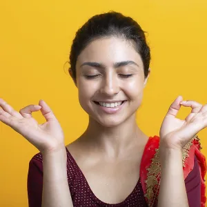 Portrait of young adult indian woman in sari meditating zen like with ok sign mudra gesture Portrait of young adult indian woman in sari meditating zen like with ok sign mudra gesture