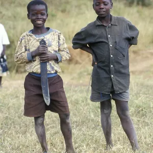 Portraits of two boys, one of them holding a large knife Portraits of two boys, one of them holding a large knife