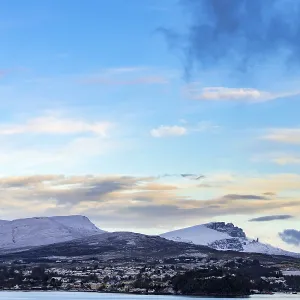 Portree in winter at sunrise with Old man of Storr and Bergen in the background Portree in winter at sunrise with Old man of Storr and Bergen in the background