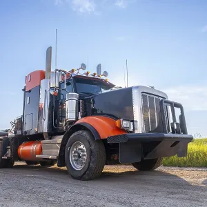 Powerful big rig semi truck with empty flatbed trailer parked on hemlock grove boardwalk in the canadian rockies Powerful big rig semi truck with empty flatbed trailer parked on hemlock grove boardwalk in the canadian rockies