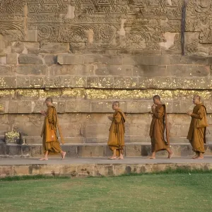 Praying Buddhist monks circling the Dhamekh Stupa Praying Buddhist monks circling the Dhamekh Stupa