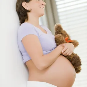 Pregnant Woman Holding a Teddy Bear Print Pregnant Woman Holding a Teddy Bear Print