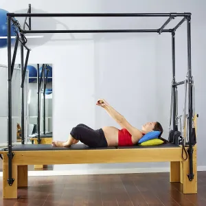 Pregnant woman pilates reformer cadillac exercise workout at gym Pregnant woman pilates reformer cadillac exercise workout at gym