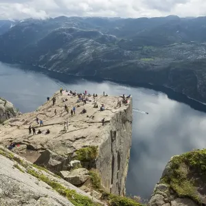 Preikestolen or Prekestolen, Preacher's Pulpit or Pulpit Rock with tourists