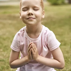 Pretty face. Red hair. Cute school child doing yoga exercise Pretty face. Red hair. Cute school child doing yoga exercise