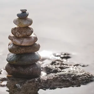 Pyramid of stones on the seashore Print - Zen Balance