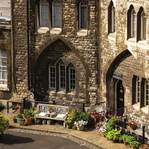 Quaint corner with cobblestone path and flowers near guard housing at The Tower of London