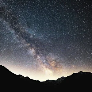 Radiant Milky Way in the sky above silhouetted mountains