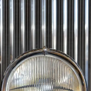 Radiator grille and headlight of retro car close up Radiator grille and headlight of retro car close up