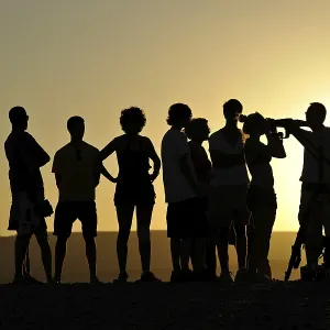 Ranger offering evening view with a telescope and binoculars of sun and stars