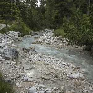 Rapid river flowing through the valley in the Italian Dolomites