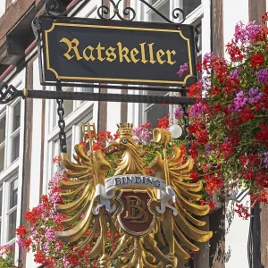 Ratskeller, sign on a flower-decorated half-timbered house Ratskeller, sign on a flower-decorated half-timbered house