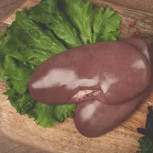 Raw pork kidneys, on a chopping board