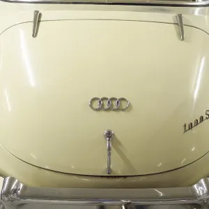Rear view of a cream-coloured Audi classic car with chrome details and classic shapes