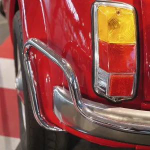 Rear view of a red classic car with characteristic tail lights