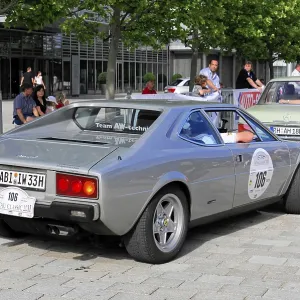Rear view of a silver Ferrari classic car in an urban environment Rear view of a silver Ferrari classic car in an urban environment