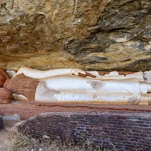 Reclining Buddha embedded in a rock wall Reclining Buddha embedded in a rock wall