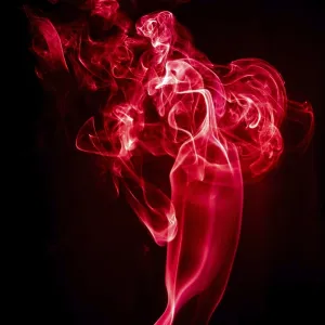 Red abstract shaped smoke against black background Red abstract shaped smoke against black background