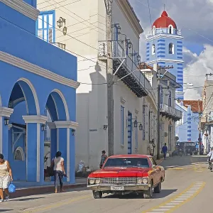 Red American classic car and bell tower of the Parroquial Mayor Red American classic car and bell tower of the Parroquial Mayor