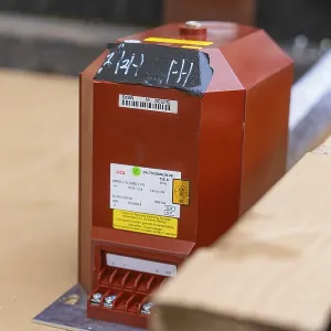 Red box with technical labels on a cardboard base