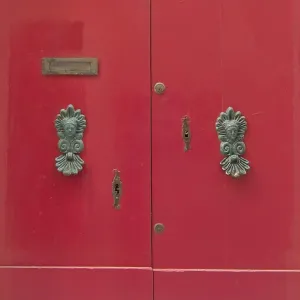 Red door with brass knobs. Painted doors of Malta series Red door with brass knobs. Painted doors of Malta series
