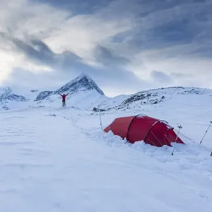 Red tent in the snow, on the long-distance hiking trail Kungsleden
