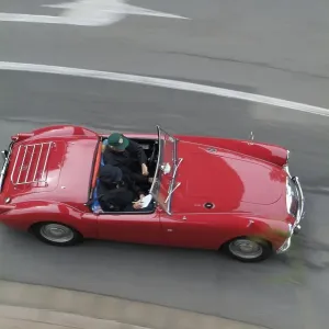Red vintage car MG driving and from above Red vintage car MG driving and from above