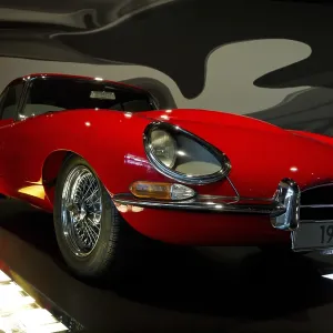 Red vintage car from the front view in an exhibition