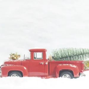 Red vintage pickup truck with a Christmas tree in winter landscape Red vintage pickup truck with a Christmas tree in winter landscape