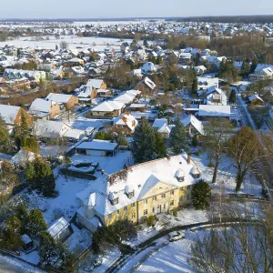 Residential area in winter with snow-covered classic buildings and trees Residential area in winter with snow-covered classic buildings and trees