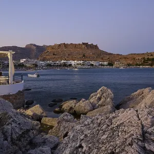 Restaurant Argo, Rock-framed view of a coastal town and sea at dusk Restaurant Argo, Rock-framed view of a coastal town and sea at dusk