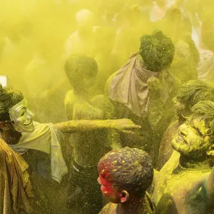 Revellers dancing in the beat of music as they celebrate Holi on a street