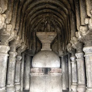 Richly stone carved stupa and pillars at Buddhist caves on mountain at Lenyadri