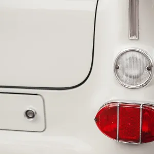 Right tail and reversing lights on a white vintage car with chrome trim