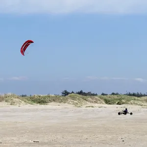 Ringby, Denmark - 30 May, 2021: kite buggy enjoying a windy day on the Wadden Sea island beaches of western Denmark Ringby, Denmark - 30 May, 2021: kite buggy enjoying a windy day on the Wadden Sea island beaches of western Denmark