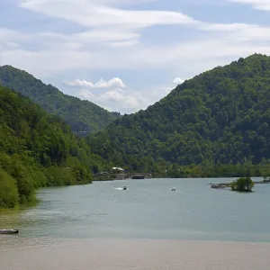 Rivers of different colors surrounded by forested mountains and blue sky