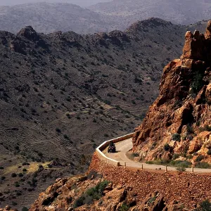 Road snakes through a rocky, dry mountain landscape