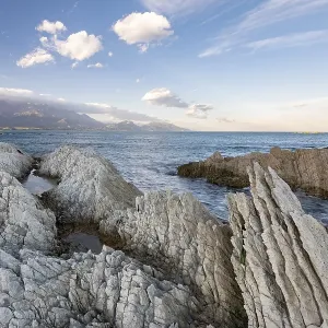 Rocky coast on the Kaikoura Peninsula, mountains of the Kaikoura Range in the background, Kaikoura, Canterbury, South Island, New Zealand, Oceania Rocky coast on the Kaikoura Peninsula, mountains of the Kaikoura Range in the background, Kaikoura, Canterbury, South Island, New Zealand, Oceania