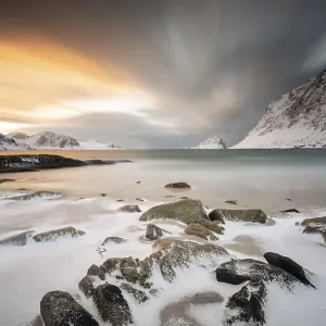 Rocky coast with snow at sunset Rocky coast with snow at sunset