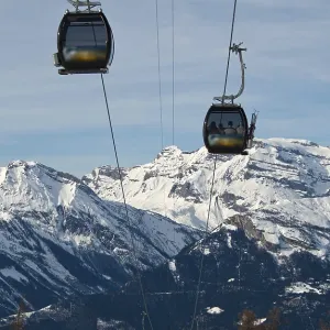 Rope-way against a background of snow-capped peaks
