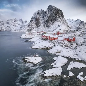 Rorbuer fishermen's cabins on the snowy fjord Rorbuer fishermen's cabins on the snowy fjord