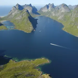Rough mountains with fjord Kjerkfjorden and boat Moskenesoya Lofoten Norway