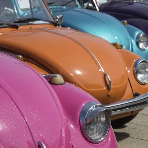 Row of colorful vintage cars parked under the sun Row of colorful vintage cars parked under the sun