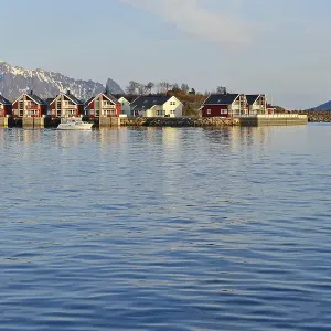 Row of red cottages by the blue water Row of red cottages by the blue water