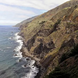 Rugged coastline with high cliffs and distant mountains