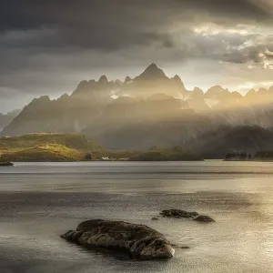 Rugged peaks of the mountain range Trolltindan in the rays of the evening sun Rugged peaks of the mountain range Trolltindan in the rays of the evening sun