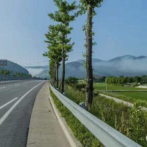 Rural highway through farmland with early morning fog in valley between mountains in South Korea